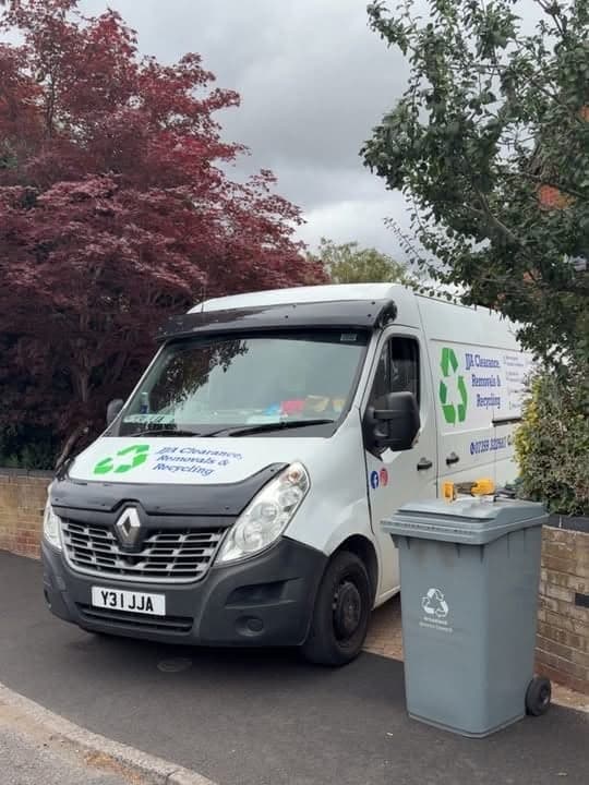 The JJA Clearance, Removals and Recycling van parked on a street, with the recycling logo on the bonnet and side